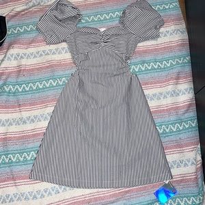 Dark blue and white striped dress with puff sleeves and waist cutouts